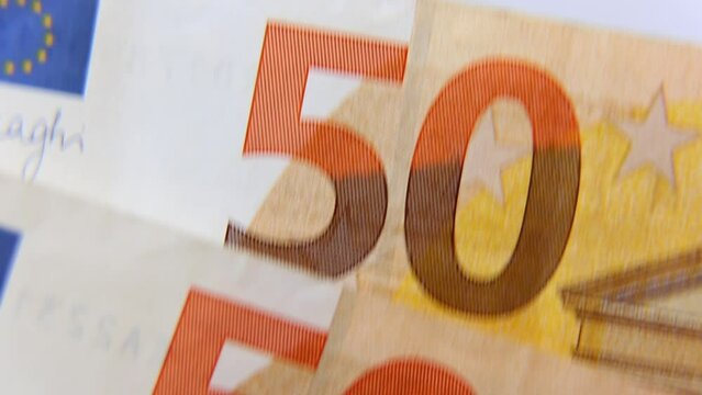 a lot of 50 euro banknotes are laughing at each other. 