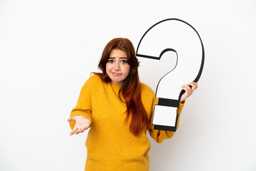 Young redhead woman isolated on white background holding a question mark icon and having doubts