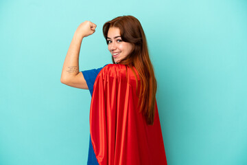 Young caucasian woman isolated on white background in superhero costume and doing strong gesture