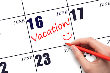 A hand writing a VACATION text and drawing a smiling face on a calendar date 16 June. Vacation...