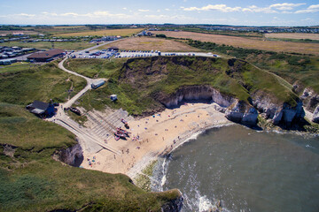 Obraz premium Aerial view of Flamborough North Landing, High Cliffs and sandy Beach, Flamborough, Yorkshire. England