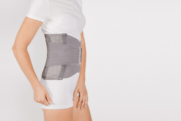 Lumbar brace on the human body isolated on a white background. Trauma of back. Back brace, orthopedic lumbar, support belt for back muscles. Lower back problems health