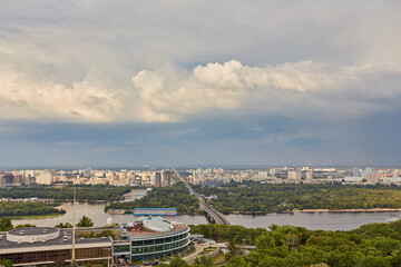 Skyline of Kyiv with Metro bridge and rainbow in the sky.