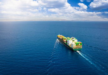 A large cargo container ship traveling over the open ocean as a concept for global trade and...