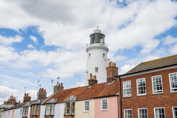 Southwold Lighthouse behind colourful houses