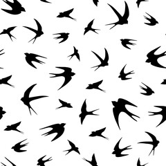 Seamless pattern with swallows flying birds, with open wings. Vector graphics.