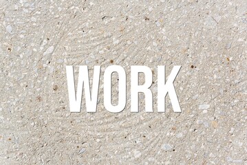 WORK - word on concrete background. Cement floor, wall.