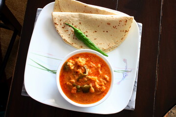 indian gujarati traditional dish food chapati or roti serve with mix vegetable masala curry