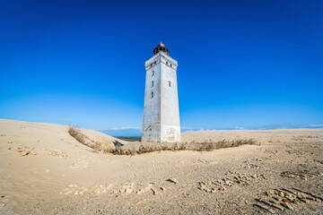 Fototapeta na wymiar The iconic lighthouse Rubjerg Knude Fyr in the dunes of northern Denmark on a summer day