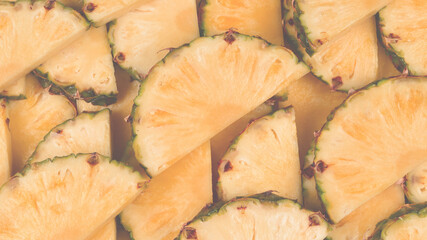 Pineapple juicy yellow slices background. Top view.