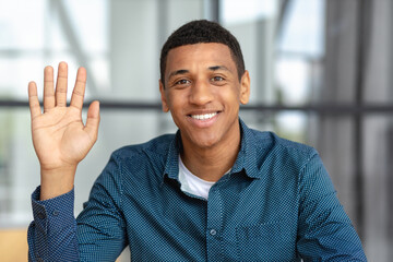 Remote work, online interview, video conference concept. Video call screen with smiling African American man introducing himself. Headshot of a positive male looking at the camera and smiling friendly © kucherav