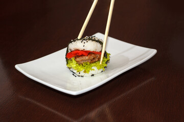 sushi burger on a plate, lazy sushi with chopsticks