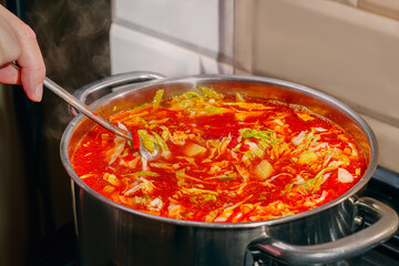 Borsch is a traditional Ukrainian Russian hot soup cooked in a large metal pot. Beets, cabbage, carrots, potatoes, peppers, onions, tomatoes are boiled in meat or vegan broth. Ukrainian food