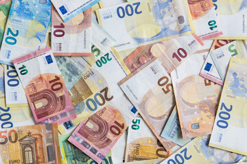 Different Euro banknotes on a desk