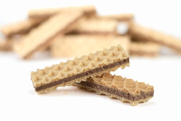 Delicious chocolate wafer on bright background. Close up view. Selective focus.