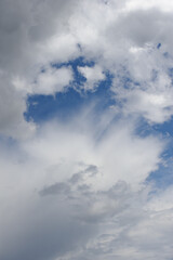 Natural background of white cumulus clouds on blue sky 