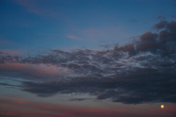 Moon and clouds on night sky 
