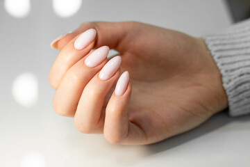 Beautiful nude manicure. Almond shaped nails. Nail design. Manicure with gel polish. Close-up of...