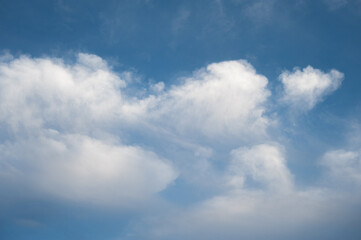 Natural background of blue sky with white cumulus clouds
