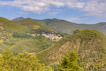 Fototapeta na wymiar Forested mountains of Cevennes with small village