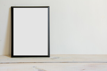black white frame on wooden background