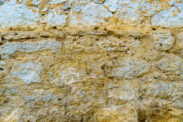 the surface of a vintage clay wall painted with white paint for a background or texture, an old house in the village