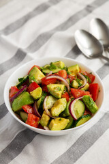Homemade Organic Cucumber, Tomato and Avocado Salad in a Bowl, side view.