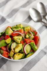 Homemade Organic Cucumber, Tomato and Avocado Salad in a Bowl, side view.