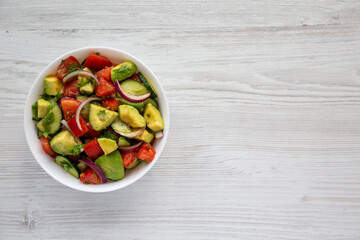 Homemade Organic Cucumber, Tomato and Avocado Salad in a Bowl, top view. Flat lay, overhead, from above. Space for text.