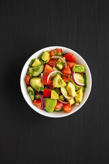 Homemade Organic Cucumber, Tomato and Avocado Salad in a Bowl, top view. Flat lay, overhead, from above.