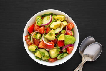 Homemade Organic Cucumber, Tomato and Avocado Salad in a Bowl, top view. Flat lay, overhead, from above.