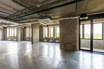 Company office with a gray walls in ndustrial style interior with big windows