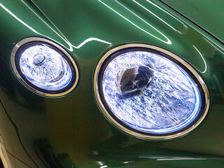 Adaptive laser front optics of a luxury car in metallic green