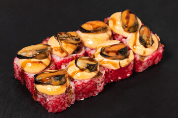 Sushi rolls with mussels and cheese on a black background. Japanese food. top view.Japanese cuisine restaurant, sushi