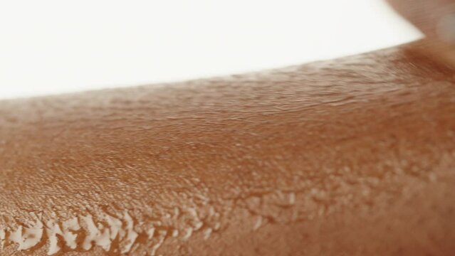 Wet black skin texture close-up. Native African American woman, hand surface with water macro shooting. Body and healthcare, hygiene and medicine concept.