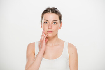 Fototapeta premium Close-up portrait of a beautiful young woman dressed in a white t-shirt isolated on white.'portrait of a young Ukrainian girl with different emotions