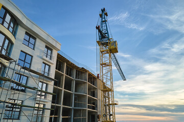 Fototapeta na wymiar Tower cranes at high residential apartment buildings construction site. Real estate development
