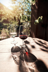two wine glasses on the vintage wooden table outside background