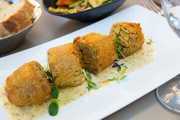 French cuisine. Pan-fried pieces of Andouillette served with mustard sauce and greens