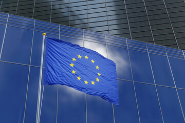 European Union (EU) flag waving in the air on commercial building background.