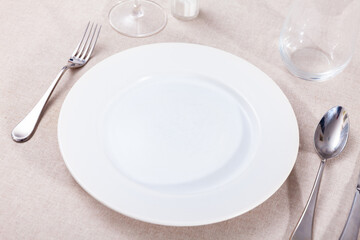 Empty plate, knife and fork served on table