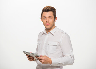 a man in a white shirt uses a tablet on a white isolated background.close-up portrait of a man with a tablet emotionally