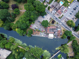 Downward drone shot of riversdie pub wwith clear water in Hoddesdon UK