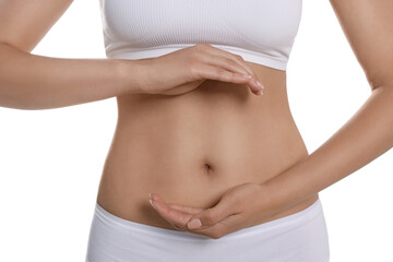 Woman in underwear holding something near her belly on white background, closeup. Healthy stomach