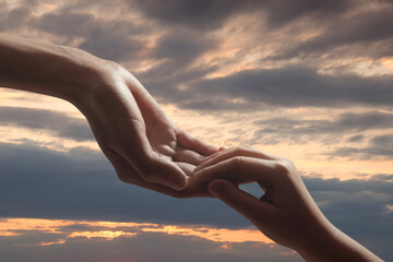 Godparent with child and beautiful sky with clouds at sunset on background, closeup