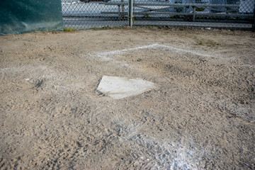 close up view of a base on a clean baseball field on a bright, sunny day