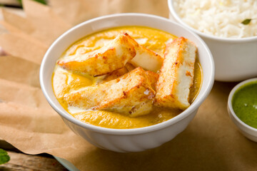 shahi paneer on white bowl with indian spices, indian cusine macro close up