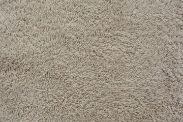 Fluffy gentle pastel biege fabric with waves and folds. Soft pastel textile texture.