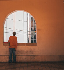 man looking out window 