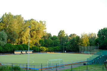 Empty high school football field with green grass.